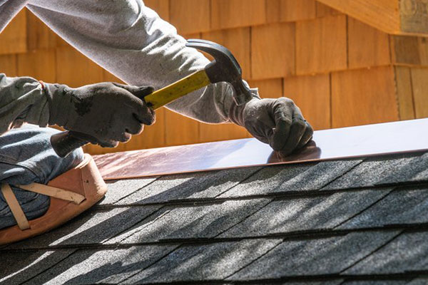 Local roofer working on shingles