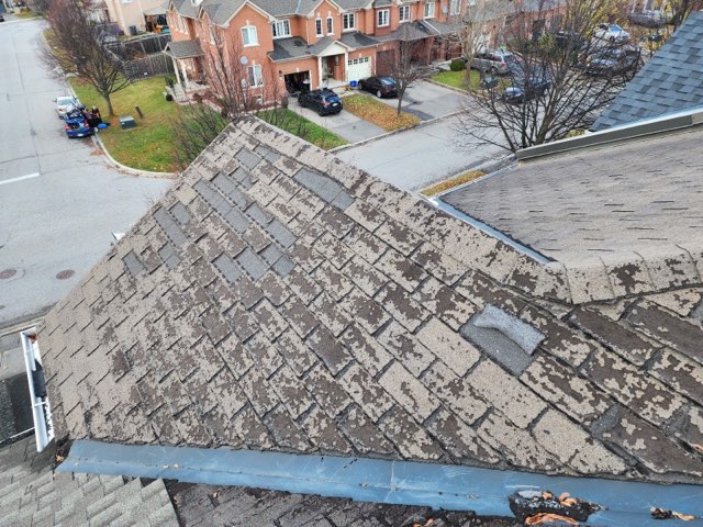 Cracked shingles as a sign of roof replacement